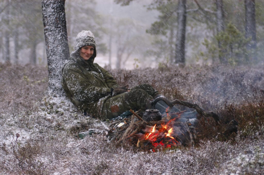 kvinne ved bål snø vinter